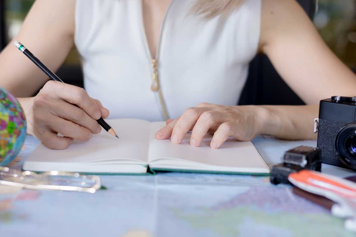 Woman traveler planning vacation trip by searching the route on the map, Travel concept.