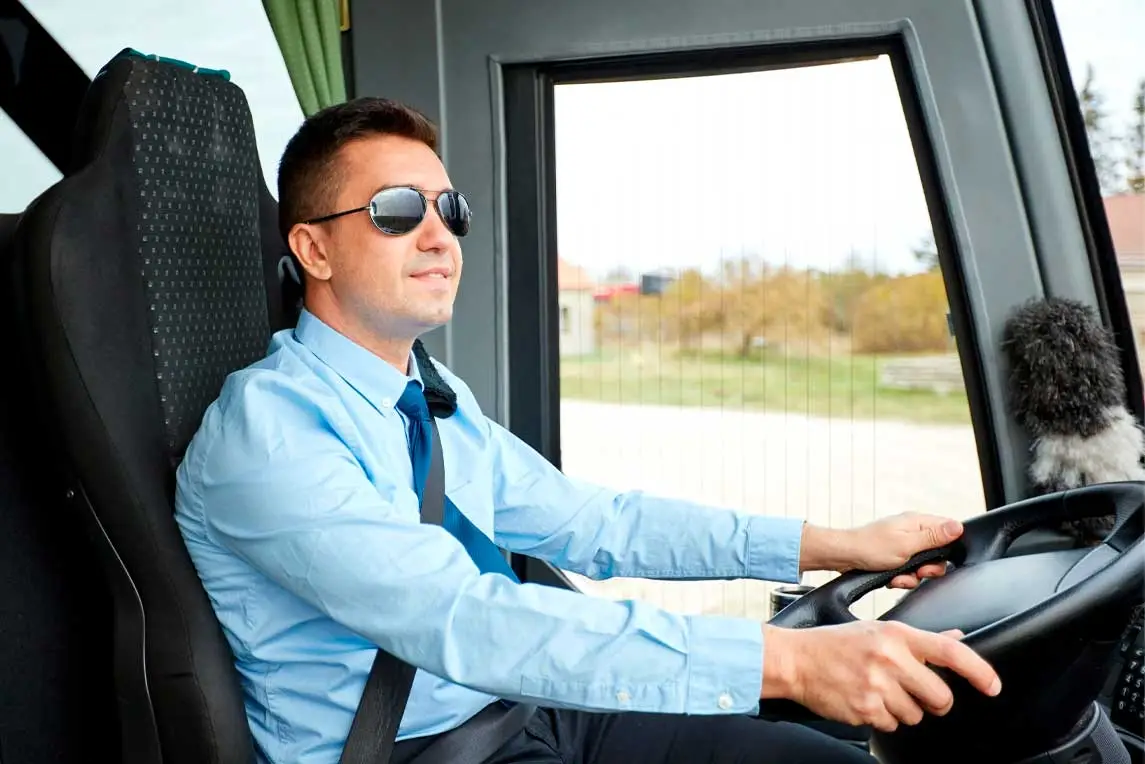 transport, tourism, road trip and people concept - happy driver driving intercity bus